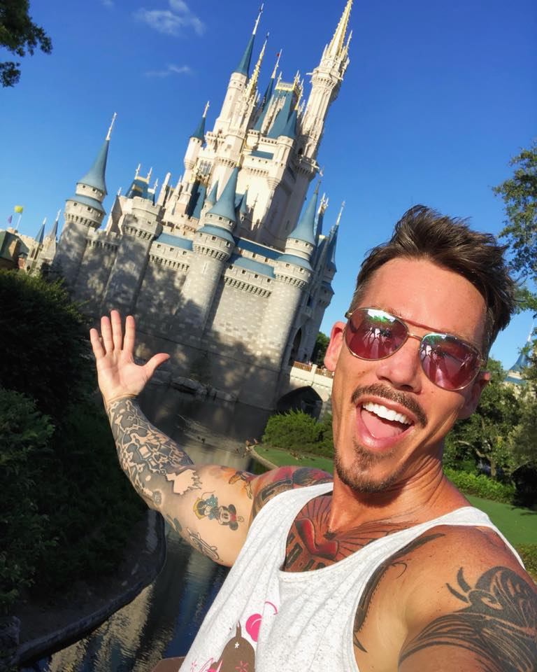 David Bromstad posing for a selfie in front of the princess castle at Disneyland