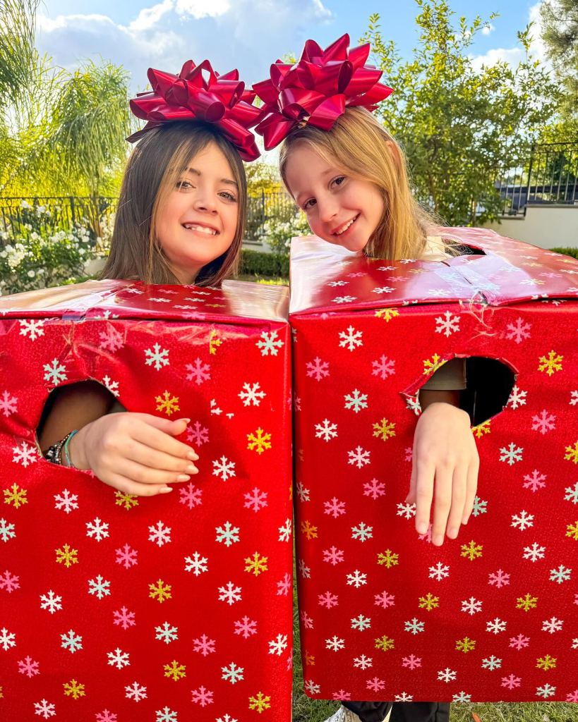 Like Natsya dressed up as gifts with Faye Knightly in the spirit of Christmas