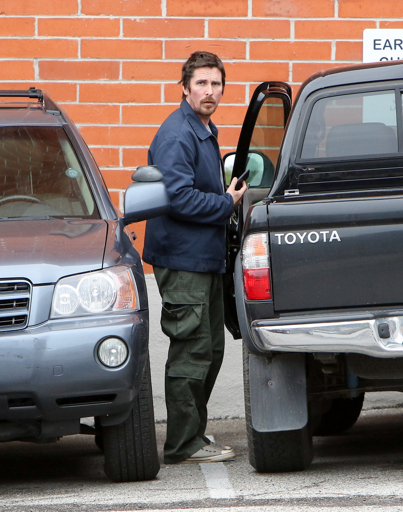 Christian Bale stepping out of his Toyota Tacoma