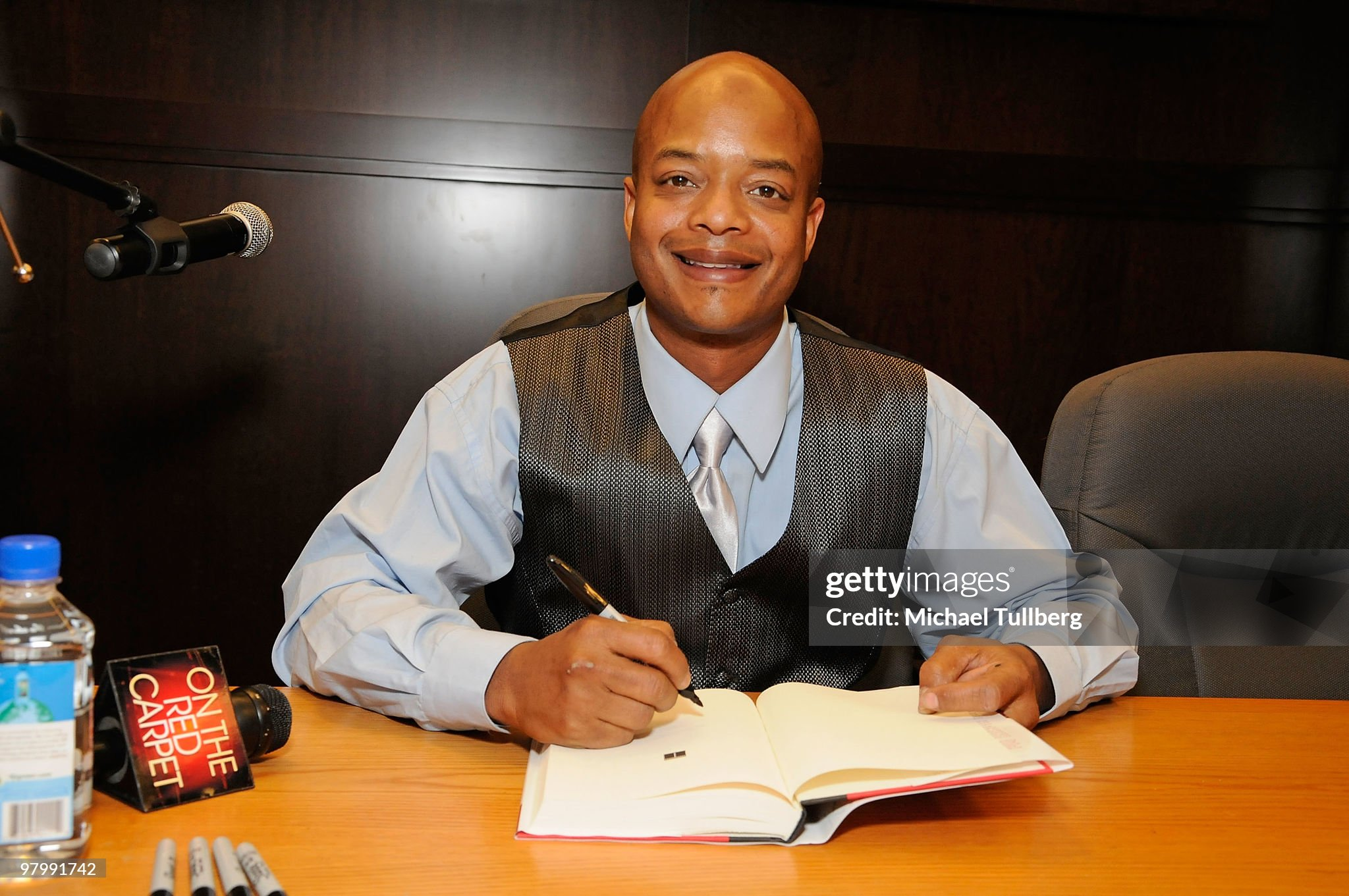 Todd Bridges poses with a copy of his book "Killing Willis" 